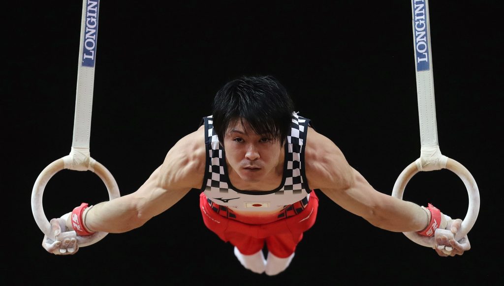 In this file photo taken on October 29, 2018 Kohei Uchimura of Japan competes in the men's rings during the Men's Team Final of the 2018 FIG Artistic Gymnastics Championships at Aspire Dome in Doha. The three-time Olympic gold medallist tested positive for Covid-19 but several subsequent follow-up tests were negative, and has been cleared to take part in an international gymnastics competition on November 8, 2020, described as a 