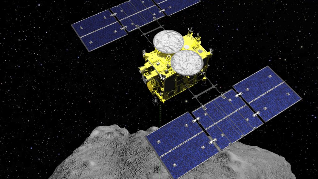 This computer graphics image released by the Japan Aerospace Exploration Agency (JAXA) shows the Hayabusa2 spacecraft above the asteroid Ryugu. The Japanese spacecraft is nearing Earth after a yearlong journey home from a distant asteroid carrying soil samples and data that could provide clues to the origins of the solar system, a space agency official said Friday, Nov. 27, 2020. (ISAS/JAXA via AP, File)