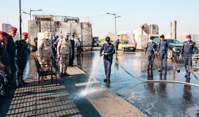 Iraqi security forces clean the Jumhuriyah bridge leading from Baghdad’s central Tahrir Square to the highly fortified Green Zone, as it reopens on Saturday. (AFP)