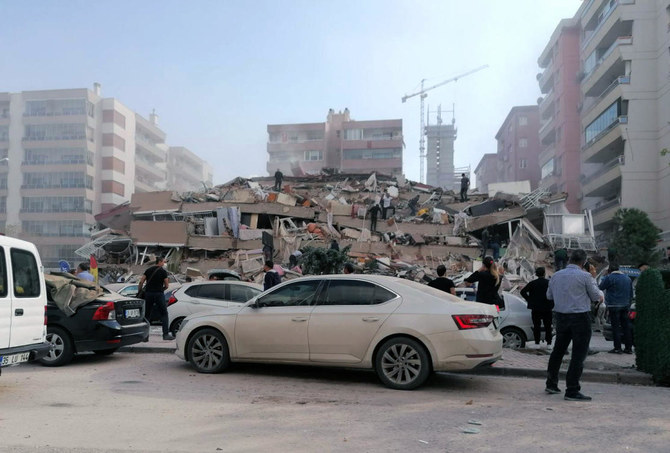 People work on a collapsed building, in Izmir, Turkey, Friday, Oct. 30, 2020, after a strong earthquake in the Aegean Sea has shaken Turkey and Greece. (AP)