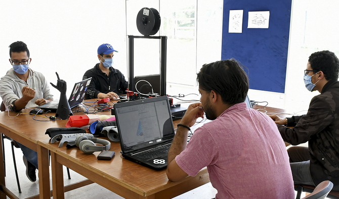 Tunisian engineers test a prototype of an artificial hand on October 20, 2020 at Cure Bionics startup in Sousse. (AFP)