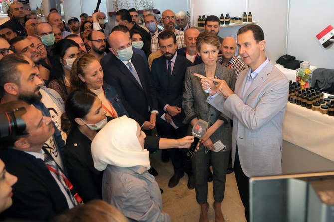 Syrian President Bashar Assad and first lady Asma Assad visit the ‘Producers 2020’ exhibition, in Damascus, Syria, Wednesday, Nov. 4, 2020. (AP Photo)