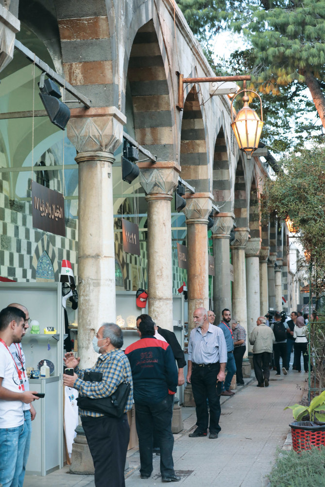 Visitors tour a trade fair dedicated to war-hit businesses from Aleppo looking to make a revival, in the Syrian capital Damascus’ Tekkiyeh Sulimaniyeh complex. (AFP)