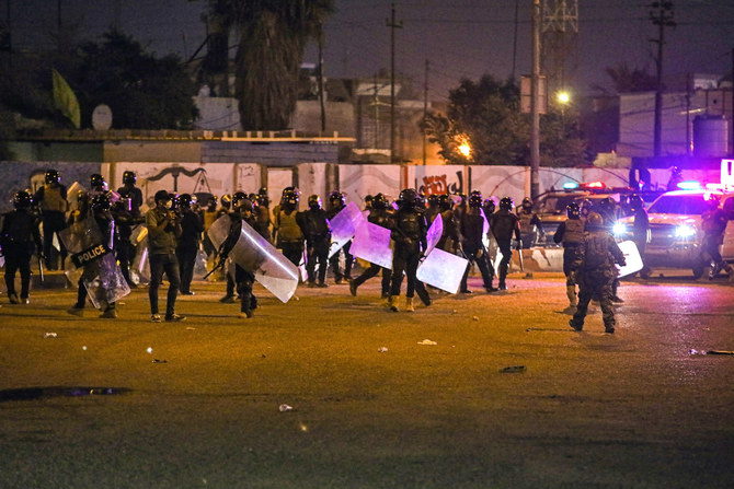 Security forces prevent anti-government protesters from setting up sit in tents in Basra, Iraq, Friday, Nov. 6, 2020. (AP)