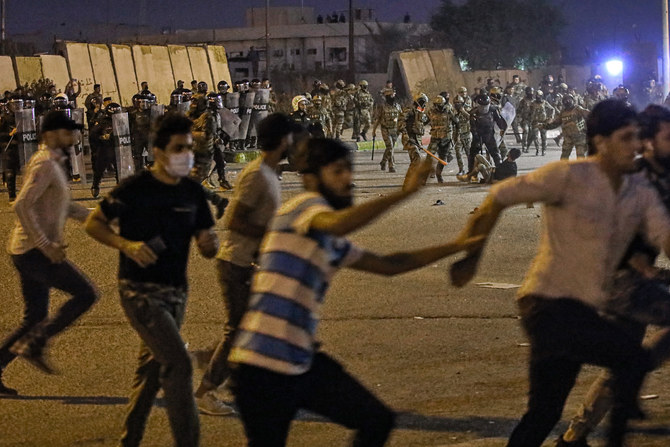 Security forces prevent anti-government protesters from setting up sit in tents in Basra, Iraq, Friday, Nov. 6, 2020. (AP)