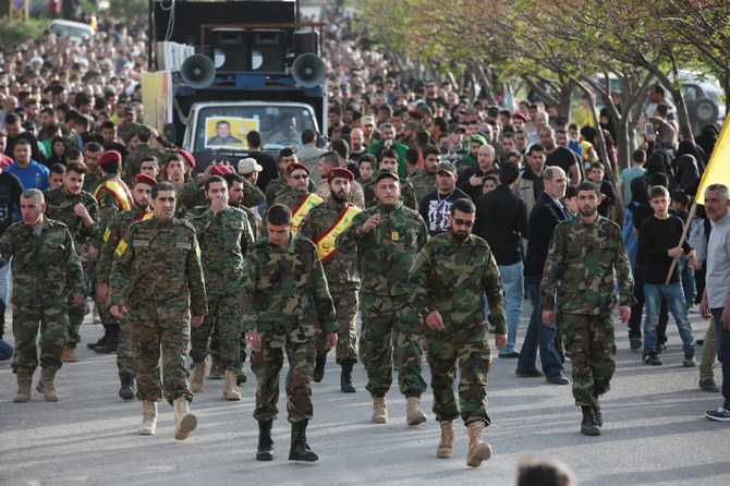 Members of the Iran-backed Hezbollah militia march in Srifa, Lebanon, during a funeral one of their commanders killed in battle in 2016. (Shutterstock photo)
