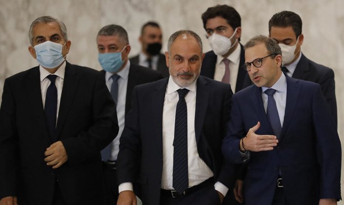 Gibran Bassil peaks with lawmaker Ziad Asswad, center, a member of his parliament bloc, at the presidential palace, in Baabda east of Beirut, Lebanon. (File/AP)