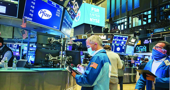 Wall Street’s main indexes hit record highs on Monday as the first successful data from a COVID-19 vaccine trial spurred hopes of the economy recovering quickly from a year of pandemic-driven crisis. (AP)