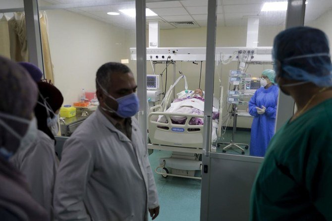 Doctors perform rounds in the intensive care unit of the Rafic Hariri University Hospital in Beirut on November 13, 2020. (AFP)