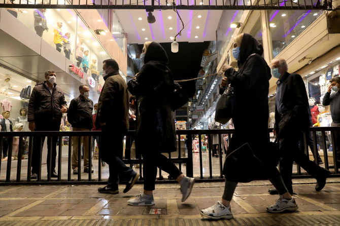 Iranian People wearing protective masks as they walk at a store, amid the outbreak of the coronavirus disease (COVID-19), in Tehran, Iran November 11, 2020. Picture taken November 11, 2020. (Reuters)