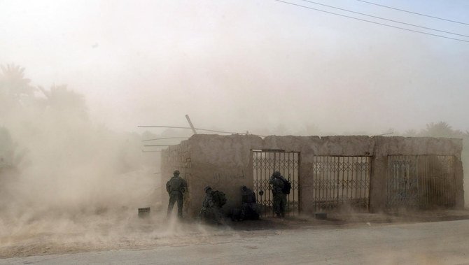 In this file photo US soldiers take cover as US Blackhawk helicopters drop troops at a US army military base in Salman Pak, south of Baghdad, on April 15, 2008. (AFP)