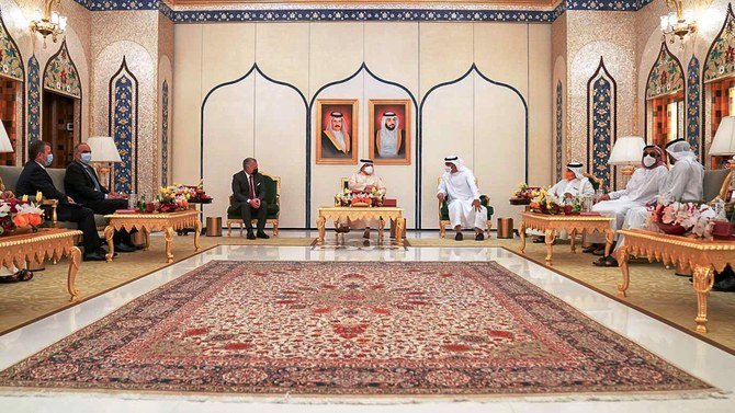 A handout picture released by the Jordanian Royal Palace on November 18, 2020 shows Jordanian King Abdullah II (C-L) meeting with Bahrain's King Hamad bin Isa Al-Khalifa (C), and Sheikh Mohamed bin Zayed Al-Nahyan (C-R), the crown prince of Abu Dhabi and deputy supreme commander of the UAE Armed Forces, during a trilateral summit in Abu Dhabi. (Jordanian Royal Palace via AFP)