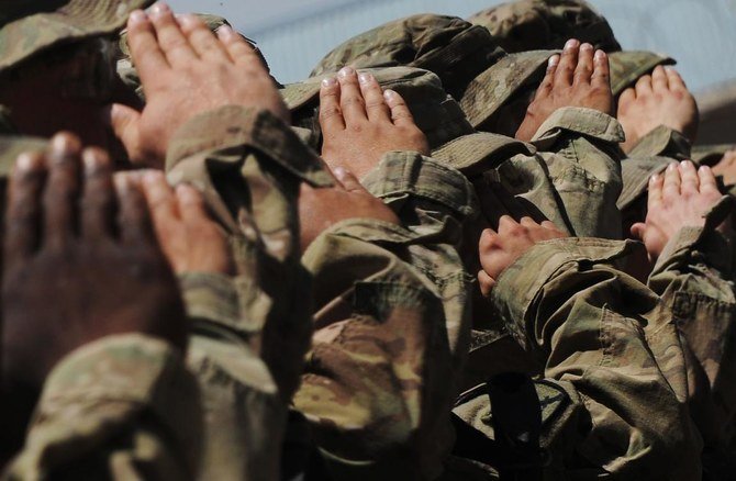 In this file photo US soldiers of the 10th Mountain Division US Army salute as the US national anthem is played during the Army Safety Excellence Award ceremony inside the Forward Operating Base(FOB) Arian at the Ghazni province on May 20, 2013. (AFP)