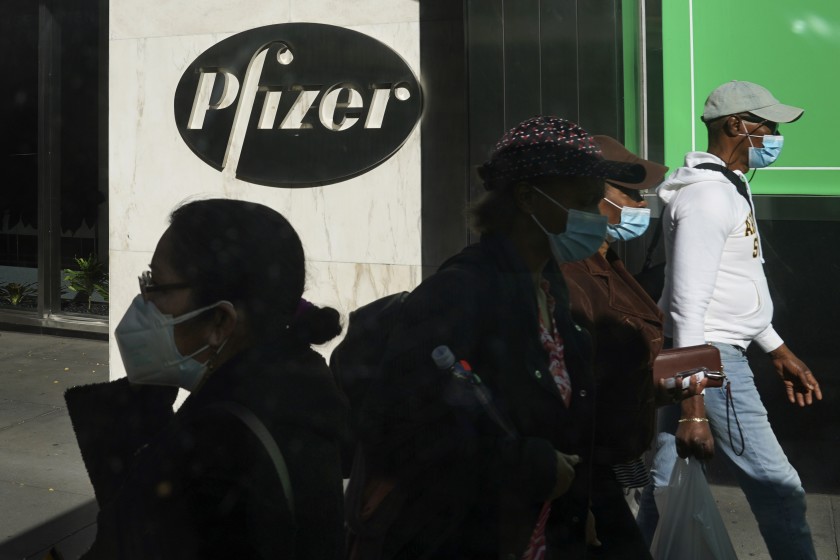 Pedestrians walk past Pfizer world headquarters in New York. (AP Photo)
