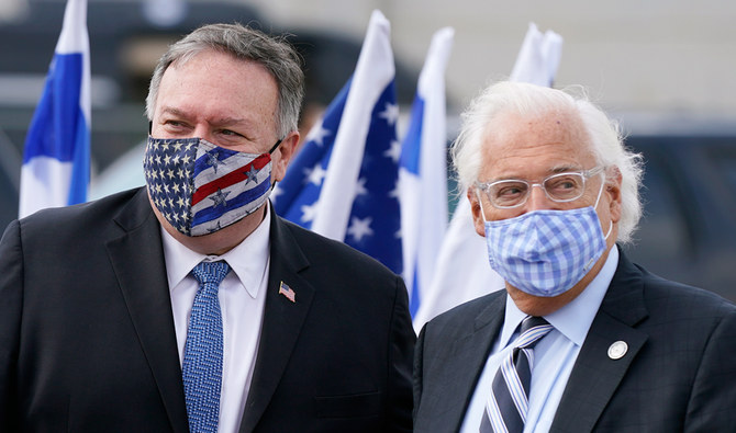 Secretary of State Mike Pompeo, left, walks with U.S. Ambassador to Israel David Friedman as he prepares to board a plane at Ben Gurion Airport in Tel Aviv, Friday, Nov. 20, 2020. Pompeo is en route to the United Arab Emirates. (AP)