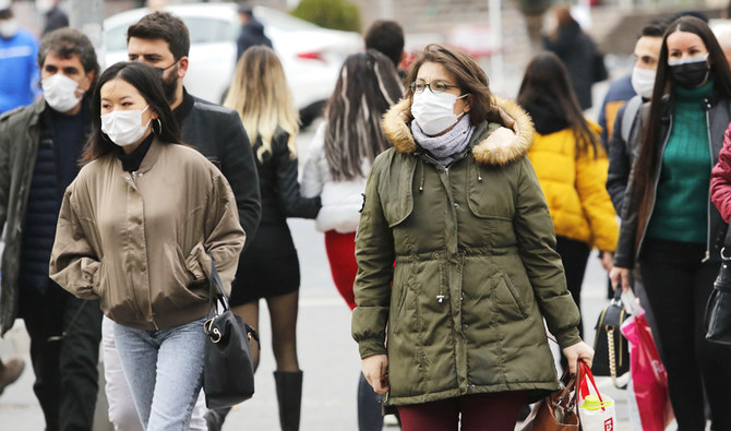 Pedestrians, wearing face masks, walk in a street of Ankara on November 20, 2020. (AFP)