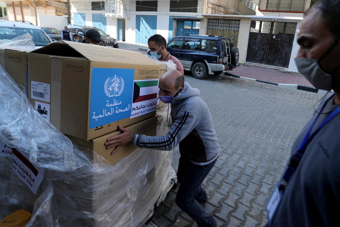 A worker unloads boxes containing ventilators delivered by the World Health Organization (WHO) and donated by Kuwait, in Gaza City November 29, 2020. (Reuters)