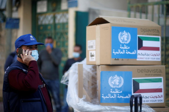 Abdelnaser Soboh, Emergency Health Lead in the World Health Organization's Gaza sub-office, stands next to boxes containing ventilators delivered by the World Health Organization (WHO) and donated by Kuwait, in Gaza City November 29, 2020. (Reuters)