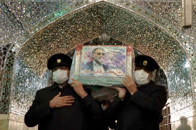A handout picture provided by Iran’s Defence Ministry on November 29, 2020 shows Servants of the Imam Reza Shrine carrying the coffin of Iran’s assassinated top nuclear scientist Mohsen Fakhrizadeh during his funeral procession in the northeastern city of Mashhad. (AFP)