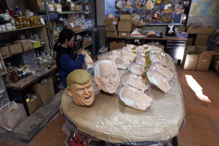 An employee adds details to rubber masks depicting President-elect Joe Biden at the Ogawa Studios in Saitama. (AP)