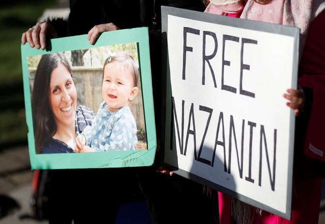Demonstrators hold placards before a march in support of Nazanin Zaghari-Ratcliffe, the British-Iranian mother who is in jail in Iran, in London, Britain. (File/Reuters)