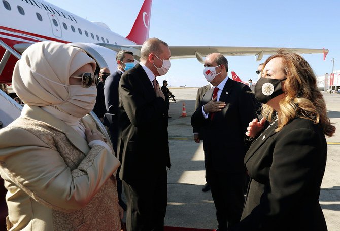 Turkey's President Recep Tayyip Erdogan (left), his wife Emine Erdogan (left), Ersin Tatar (second right), and his wife Sibel Tatar, greet each other during a welcome ceremony at Ercan Airport, in Nicosia, Northern Cyprus, Sunday, Nov. 15, 2020. (AP)