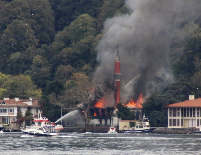 A fire engulfs Vanikoy Mosque, a historic wooden mosque, in Istanbul, Sunday, Nov. 15, 2020. The Vanikoy Mosque is located on the Asian side of Istanbul along the Bosporus Strait. (AP)
