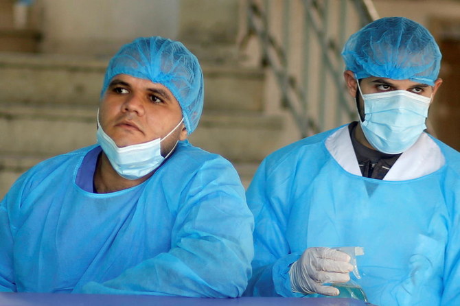 Palestinian healthcare workers wait to check patients at Shifa hospital amid the coronavirus disease (COVID-19) outbreak, in Gaza City November 22, 2020. (Reuters)