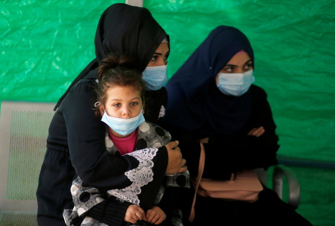 Palestinians wearing protective face masks sit at Shifa hospital amid the coronavirus disease (COVID-19) outbreak, in Gaza City November 22, 2020. (Reuters)