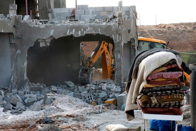 Israeli machinery demolish a Palestinian house located within the area C (where Israel retains control, including over planning and construction) near Yatta in the southern area of the West Bank town of Hebron, on November 2, 2020. (AFP)