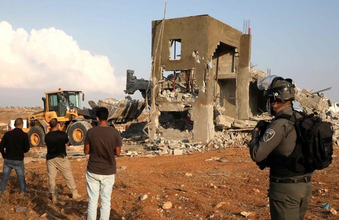Israeli machinery demolish a Palestinian house located within the area C (where Israel retains control, including over planning and construction) near Yatta in the southern area of the West Bank town of Hebron, on November 2, 2020. (AFP)