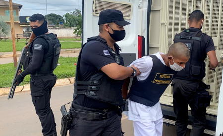 Rafael Lima da Costa, who confessed to killing Japanese woman Hitomi Akamatsu, 43, is escorted by a police officer in Abadiania, Goias state, Brazil, November 19, 2020. (Reuters)