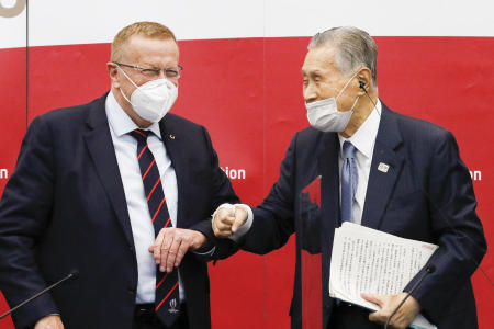 Yoshiro Mori, president of the Tokyo 2020 organizing committee, (right), greets John Coates, chairman of the Coordination Commission for the Tokyo 2020 Olympics, during a press conference in Tokyo, Wednesday, Nov. 18, 2020. (AP)