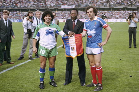 In this May 23, 1998 file photo, soccer stars Argentina's Diego Maradona (left), Pele of Brazil (center) and France's Michel Platini pose shaking hands during Platini's jubilee at Nancy stadium, eastern France. (AP)