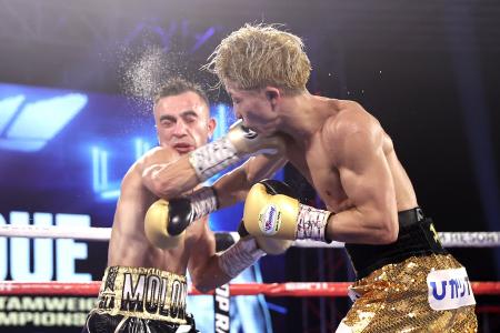 Japanese boxer Naoya Inoue (right) and Australian boxer Jason Moloney exchange punches during their bantamweight title bout at MGM Grand Conference Center on October 31, 2020 in Las Vegas, Nevada. (AFP)