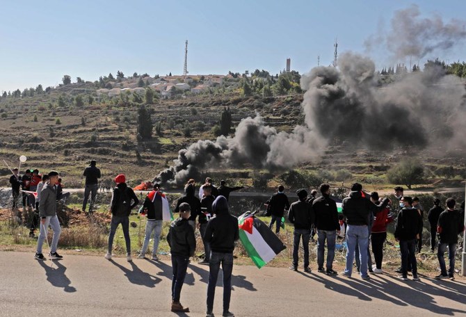 Palestinians demonstrate near the Israeli settlement of Psagot, built on the lands of the city of al-Bireh, against the visit by US Secretary of State to the settlement, on November 18, 2020 in the occupied West Bank. (AFP)