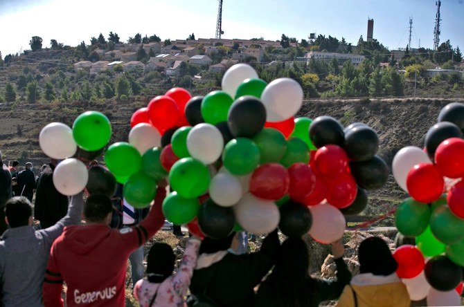 Palestinians demonstrate near the Israeli settlement of Psagot, built on the lands of the city of al-Bireh, against the visit by US Secretary of State to the settlement, on November 18, 2020 in the occupied West Bank. (AFP)