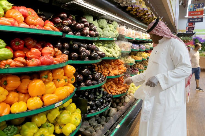 A Saudi man wearing protective gloves buys vegetables at a supermarket in Riyadh, Saudi Arabia. (File/Reuters)