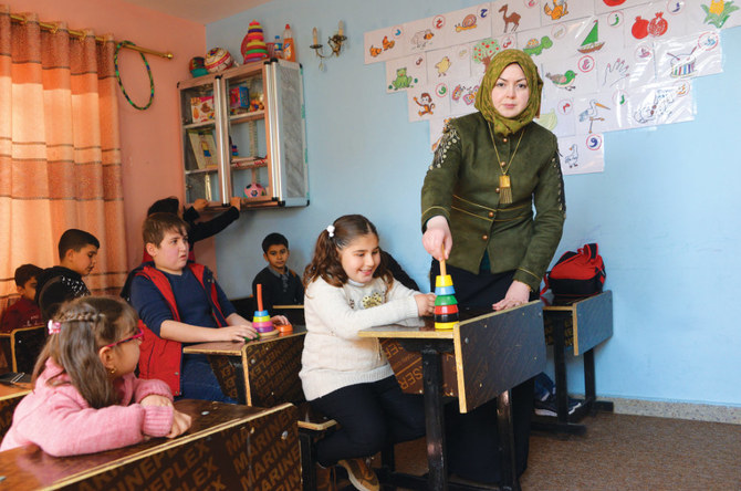 Children with special needs attend a class at a rehabilitation center in Iraq's northern city of Mosul on March 4, 2020. (AFP/Zaid Al-Obeidi)