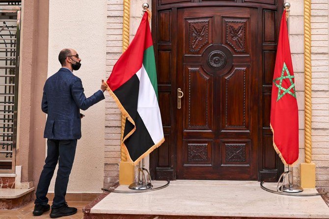 A man adjusts the UAE flag at the new consulate in Laayoun. (AFP)