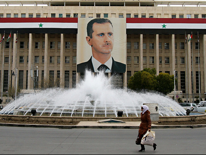 A picture of Syria’s President Bashar Assad is seen on a central bank building in Damascus. (File/Reuters)