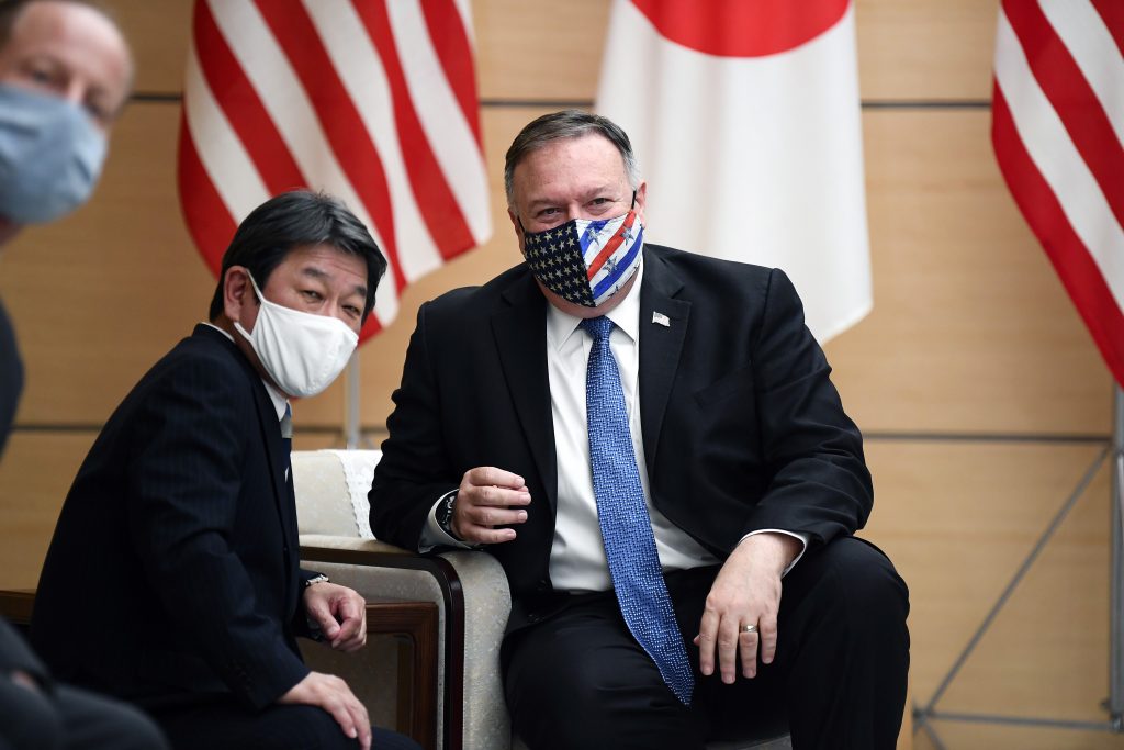 US Secretary of State Mike Pompeo (R) and Japan's Foreign Minister Toshimitsu Motegi (C) chat as they wait for Japan's Prime Minister Yoshihide Suga (not pictured) during a meeting at the prime minister's office in Tokyo on October 6, 2020. (AFP)