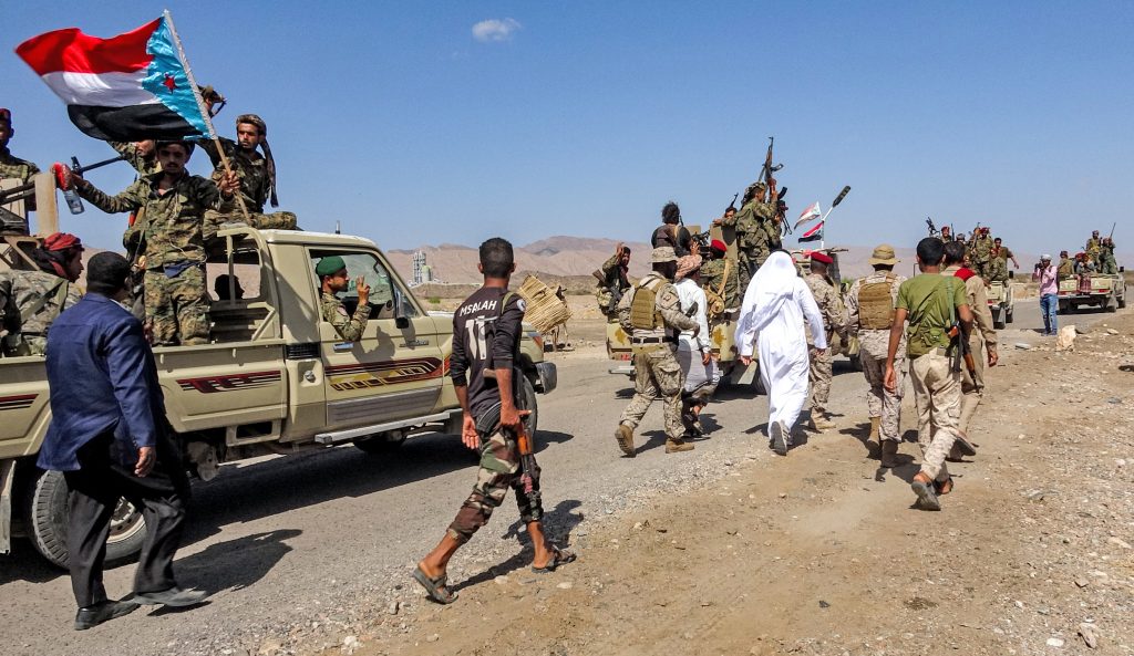 Fighters loyal to Yemen's separatist Southern Transitional Council (STC) travel in a convoy in Yemen's southern Abyan province, on December 13, 2020, as part of a withdrawal according to a power sharing agreement brokered in the Saudi capital Riyadh days earlier. (AFP)