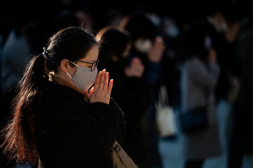 Visitors say prayers at Meiji Shrine before it closes early on New Year's Eve in Tokyo on December 31, 2020. (Photo by Philip FONG / AFP)