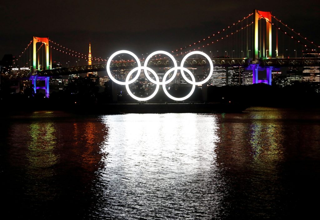 The giant Olympic rings which were temporarily taken down in August for maintenance are illuminated after being reinstalled at the waterfront area at Odaiba Marine Park, amid the coronavirus disease (COVID 19) outbreak, in Tokyo, Japan December 1, 2020.  (Reuters) 