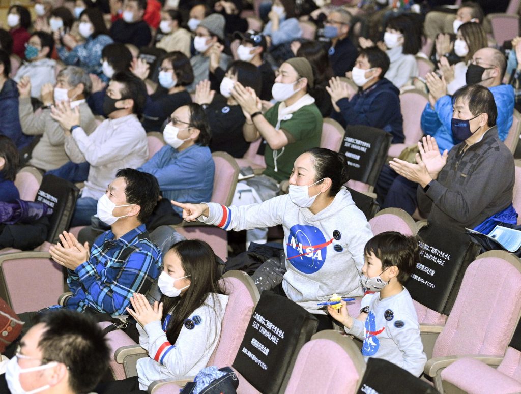 Participants celebrate as Japan Aerospace Exploration Agency (JAXA) Hayabusa2's capsule enters the earth's atmosphere at a public viewing event in Sagamihara, Japan, in this photo taken by Kyodo December 6, 2020. Mandatory credit Kyodo/via REUTERS