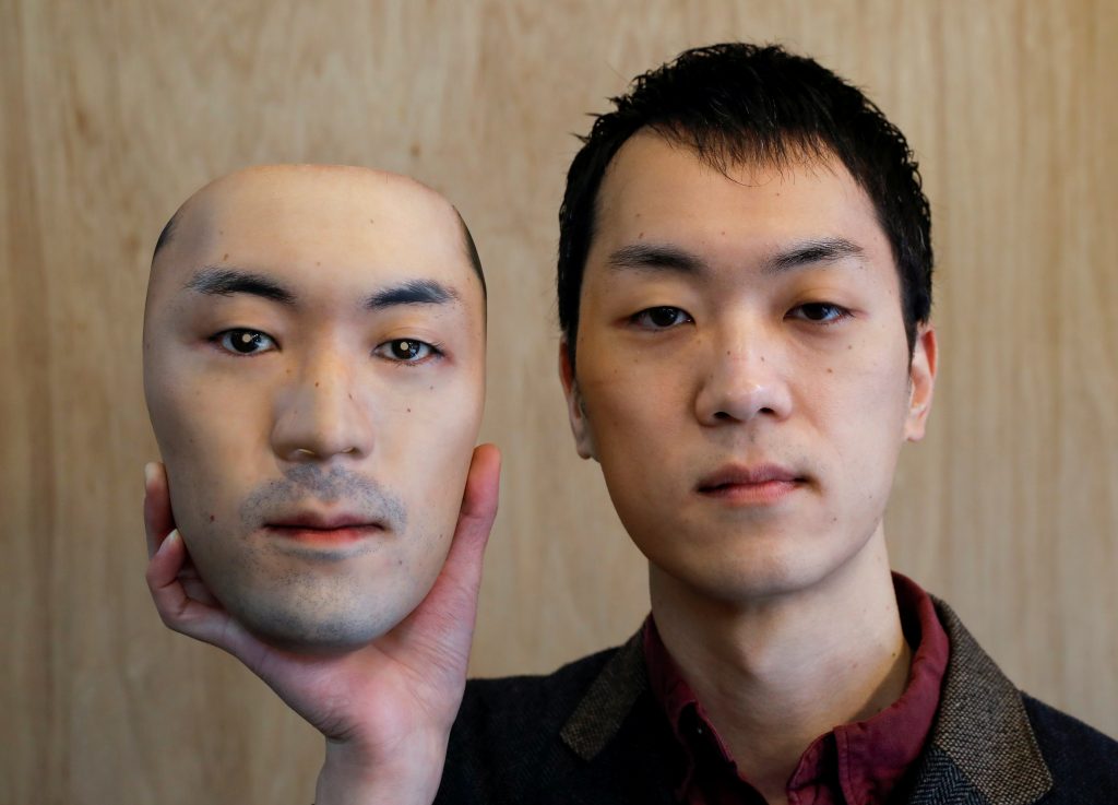 Shuhei Okawara, 30, owner of mask shop Kamenya Omote, holds a super-realistic face mask based on his real face, made by using 3D printing technology, in Tokyo, Japan December 16, 2020. (REUTERS)