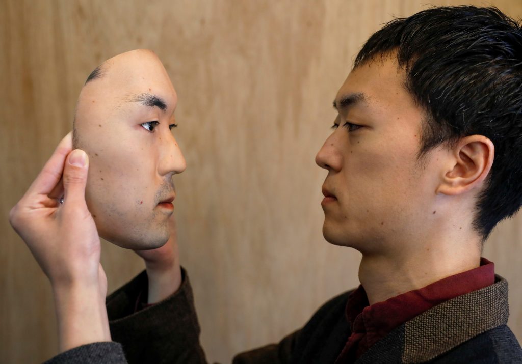 Shuhei Okawara, 30, owner of mask shop Kamenya Omote, holds a super-realistic face mask based on his real face, made by using 3D printing technology, in Tokyo, Japan December 16, 2020. (REUTERS)