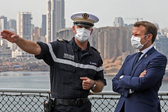 French President Emmanuel Macron speaks with Arnaud Tranchant, commander of the Tonnerre helicopter carrier, off the port of Beirut. (File/AFP)
