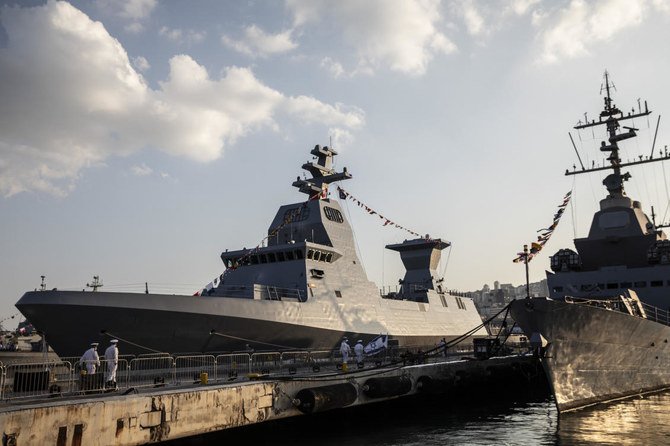 Israeli sailors walk on a pier by the first of four new Sa'ar 6 ships, left, in Haifa, Israel on Wednesday, Dec. 2, 2020. (AP)